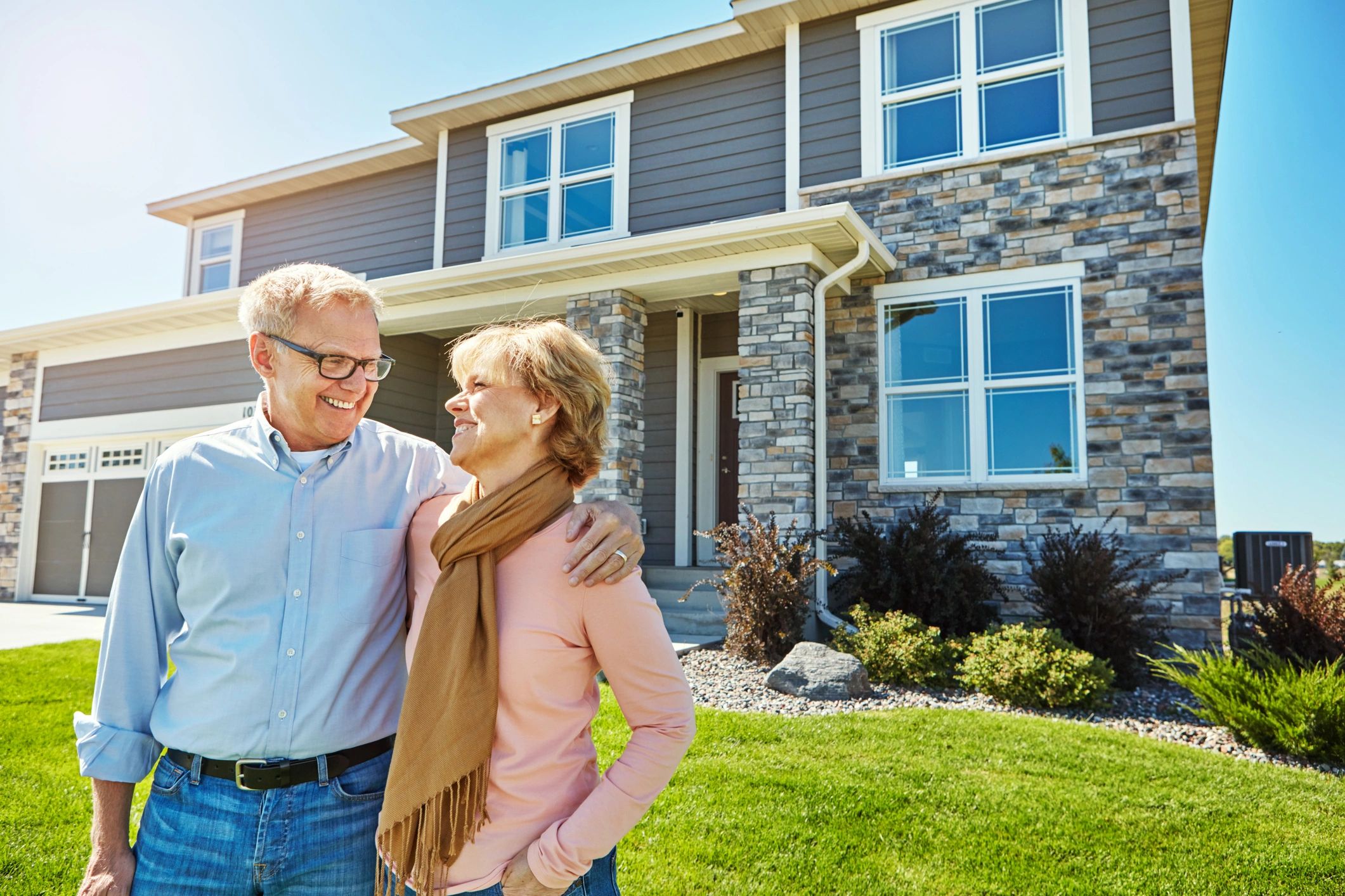 Happy couple outside a new home